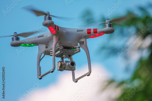 Modern Drone Quadrocopter with a camera and flashing red and