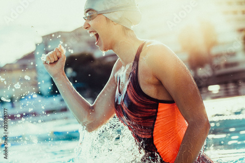 Excited female swimmer celebrating victory