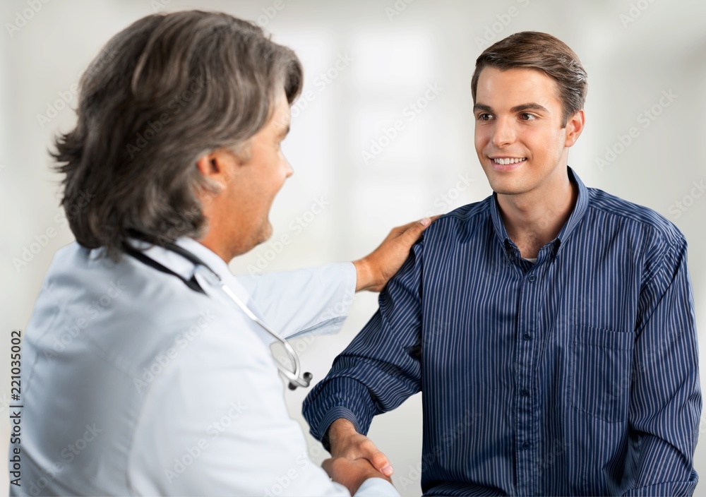 Smiling male patient with doctor on background Smiling male patient with doctor on background