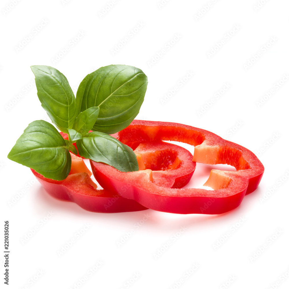 Red sweet bell pepper slices and basil leaves isolated on white background cutout Red sweet bell pepper slices and basil leaves isolated on white background cutout