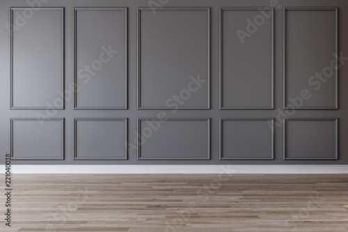 Empty room with dark gray wall, moldings and wooden floor