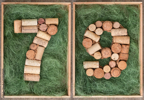 Number 79 seventy nine  made of wine corks on green background in wooden box photo