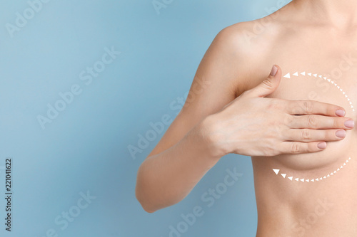 Fototapeta Woman with marks on breast and space for text against color background
