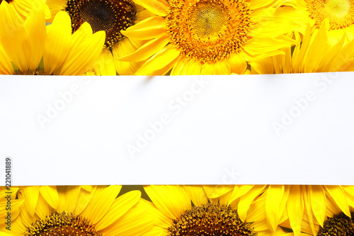 Fototapeta Naklejka Na Ścianę i Meble -  Beautiful bright sunflowers and card as color background