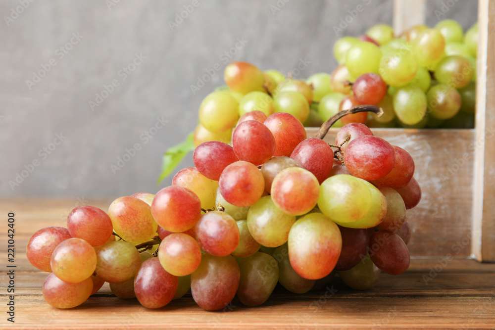 Fresh ripe juicy grapes on table against blurred background Fresh ripe juicy grapes on table against blurred background