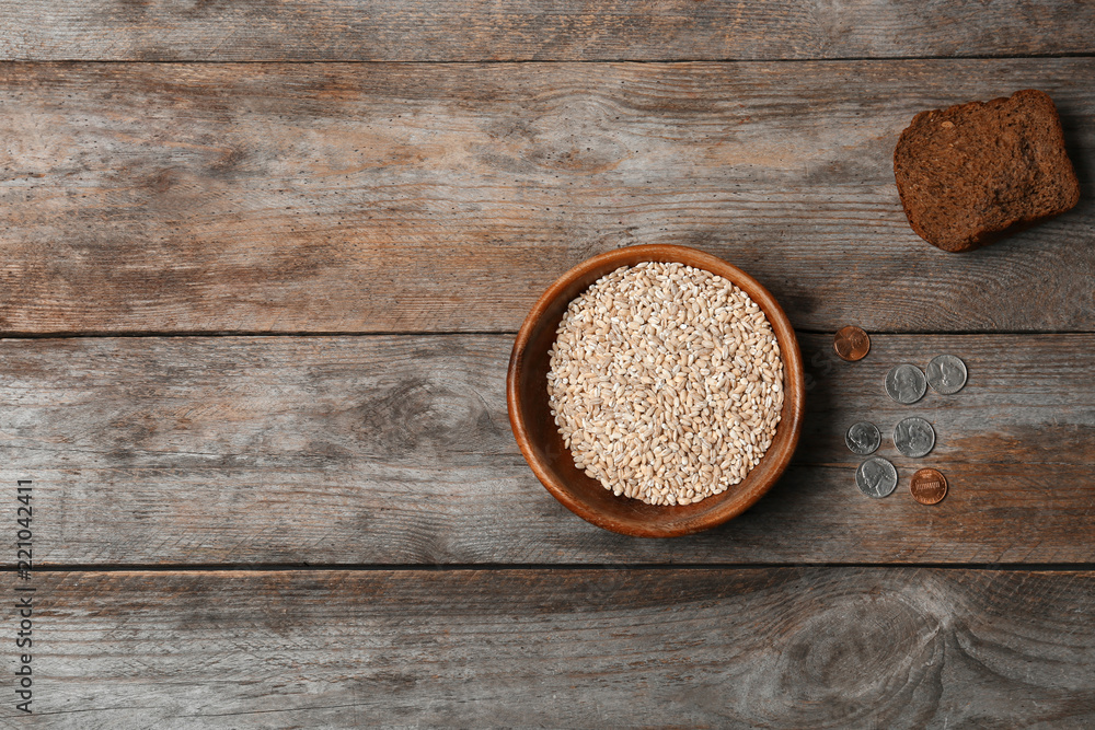 Flat lay composition with food, coins and space for text on wooden background. Poverty concept Flat lay composition with food, coins and space for text on wooden background. Poverty concept
