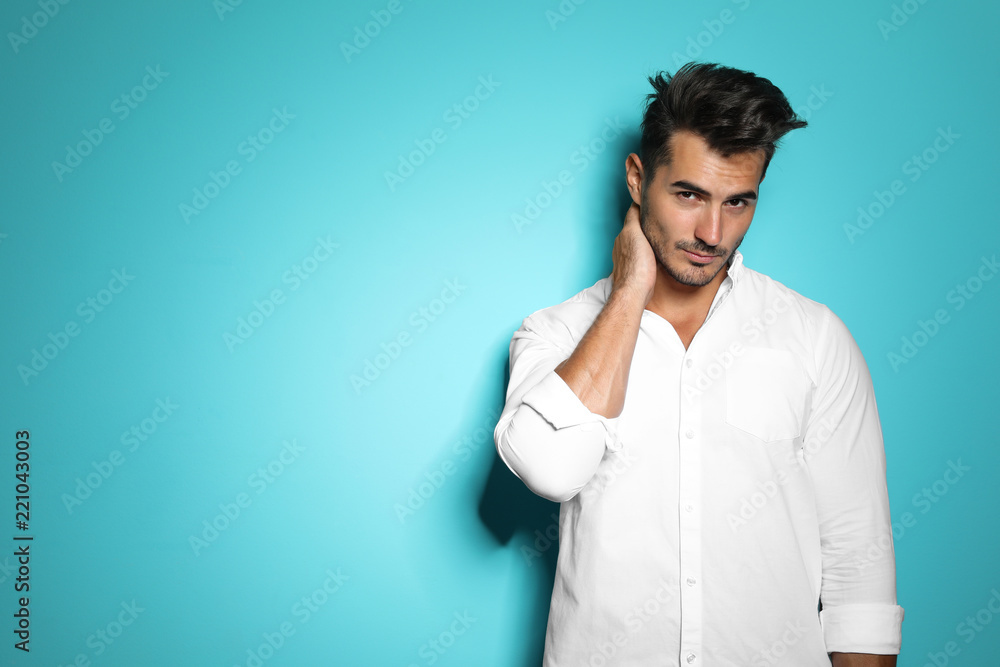 Young man with trendy hairstyle posing on color background Young man with trendy hairstyle posing on color background