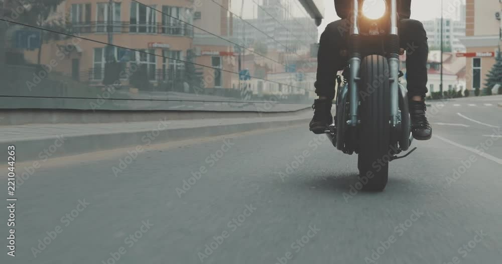 Video Stock Motorcyclist drives on a motorcycle on the road in the city ...