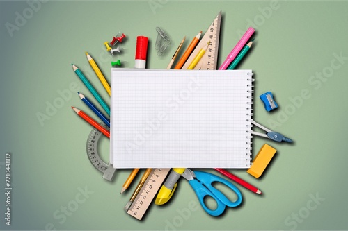 Colorful school supplies on wooden table background