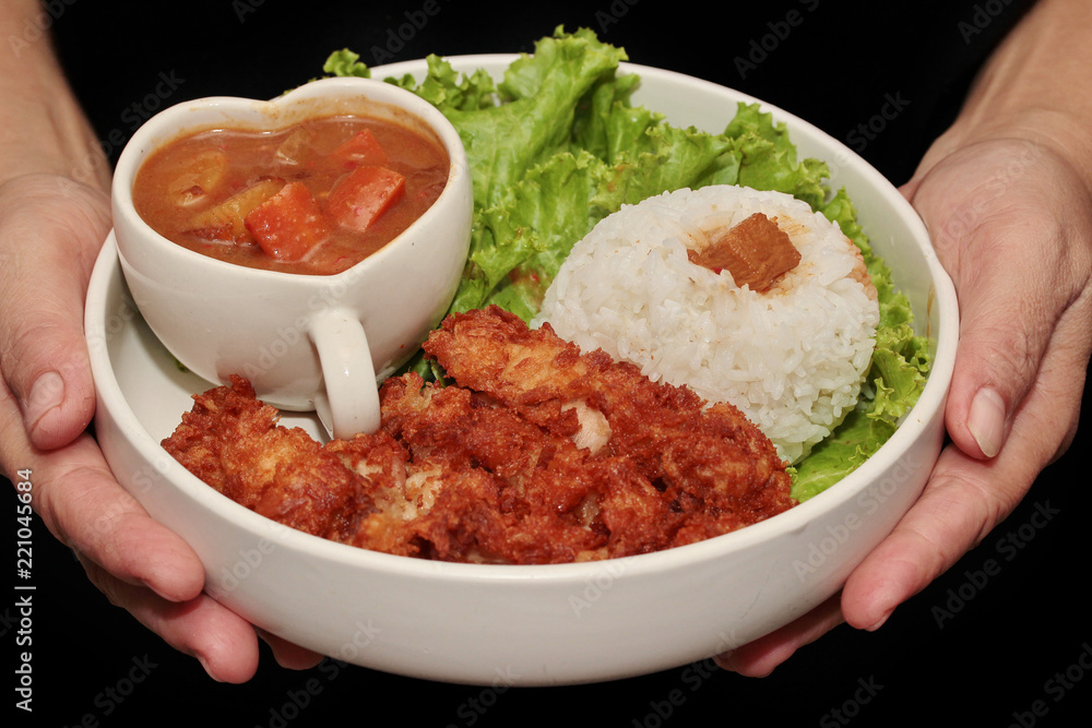 Jasmine rice with deep fried chicken and Japanese yellow curry . Jasmine rice with deep fried chicken and Japanese yellow curry .