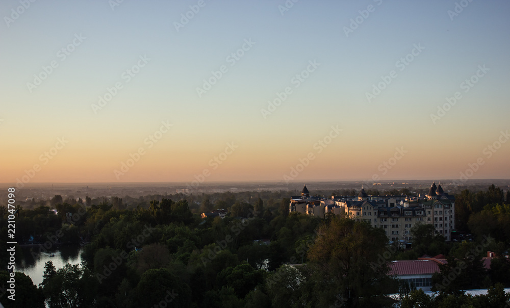 view of the city and the lake at sunset in Almaty