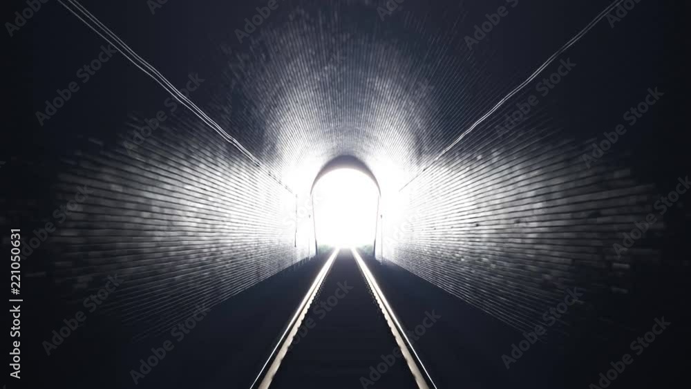 Train leaving an old underground tunnel. Train driver perspective. Bright light.
