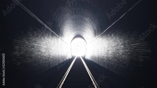 Train leaving an old underground tunnel. Train driver perspective. Bright light. photo