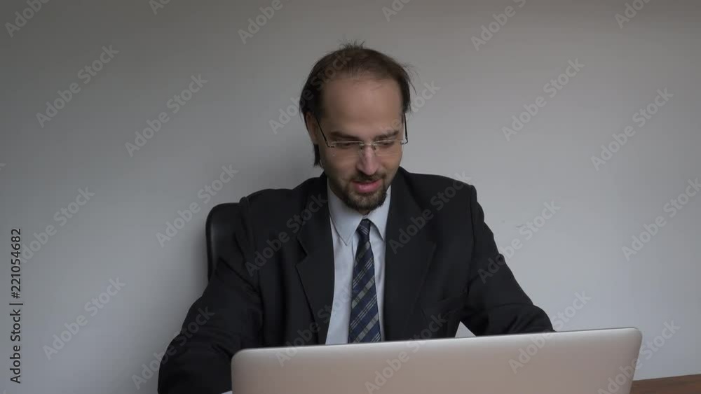 Office young businessman relaxed working with laptop frontal shot Office young businessman relaxed working with laptop frontal shot