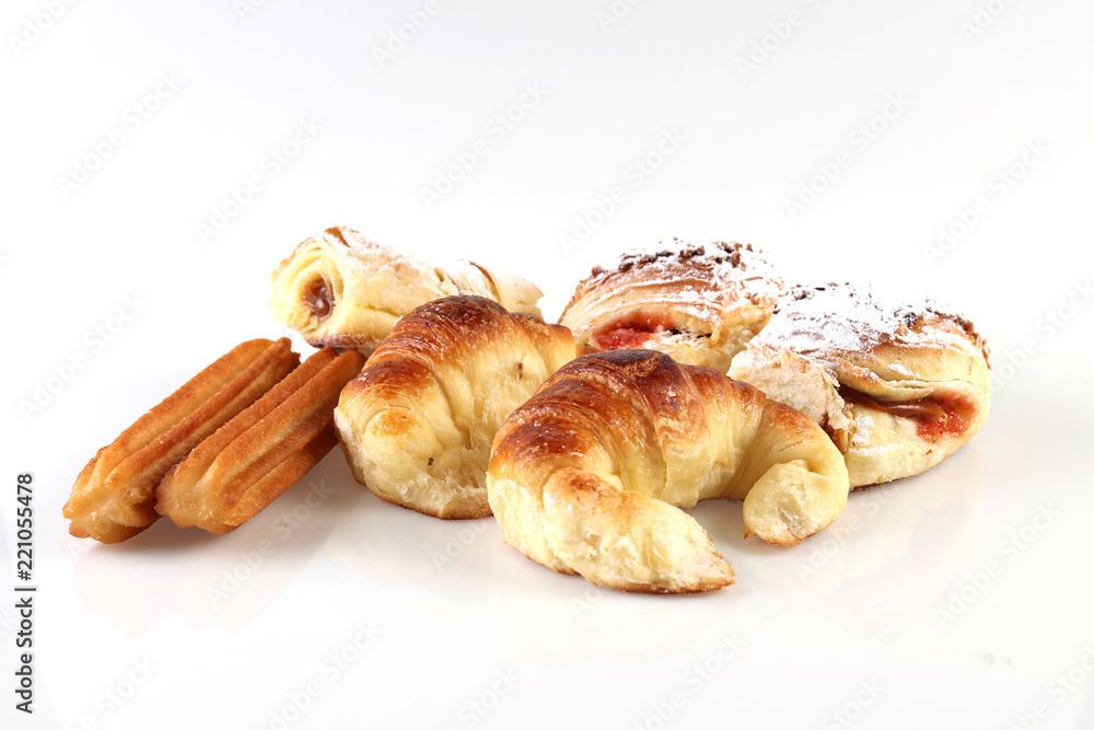Typical Argentina sweet pastry usually eaten on breakfast called “Facturas” placed on a wooden table.