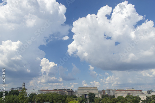 Cumulus clouds fill the sky over the National Mall in Washington, DC. National Archives are at center..