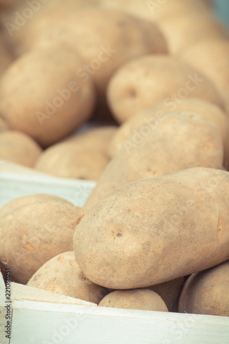 Closeup of potatoes in wooden box  concept of vegetable harvest