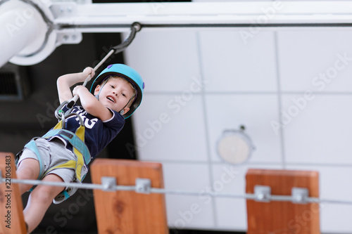 Young child crossing a bridge at the high rope course