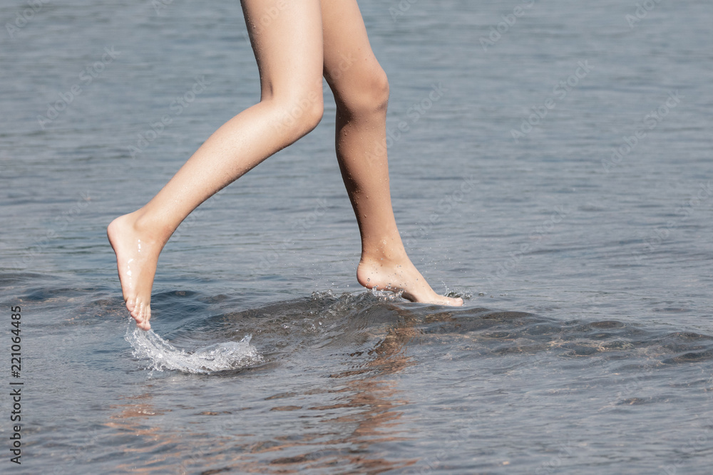 Child jumping over the waves at the lake. Child jumping over the waves at the lake.