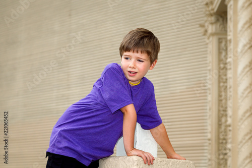 Double Jointed Young Boy with Hypermobility of the Elbow Leans Forward with Weight on his Arm photo