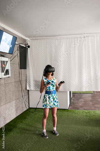 Girl in dress plays in virtual reality