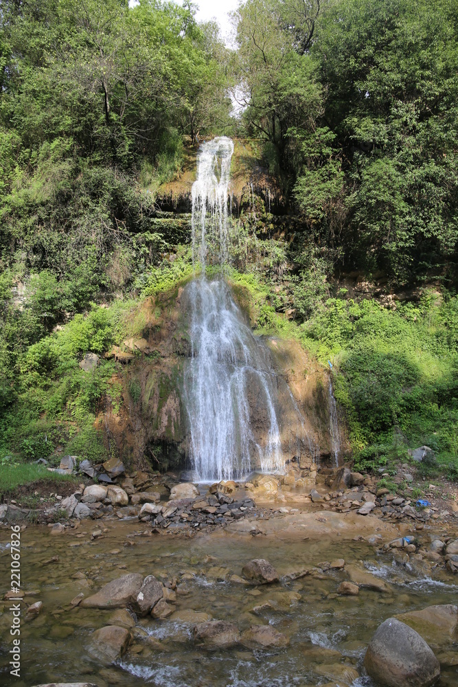 Fototapeta Waterfall in deep green forest