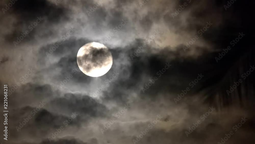 Full Moon at Mysterious Dark Night Sky. Spooky Theme for Halloween. Dramatic Clouds in the Moonlight Full Moon at Mysterious Dark Night Sky. Spooky Theme for Halloween. Dramatic Clouds in the Moonlight