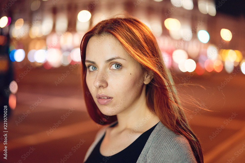 redheaded girl on the background of the night city redheaded girl on the background of the night city
