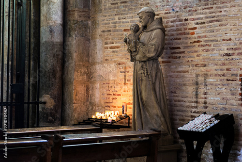 Saint Anthony of Padua holding baby Jesus statue in Saint Sernin church, Toulouse, France. It is a church destination of pilgrimage on the way to Santiago of Compostela photo