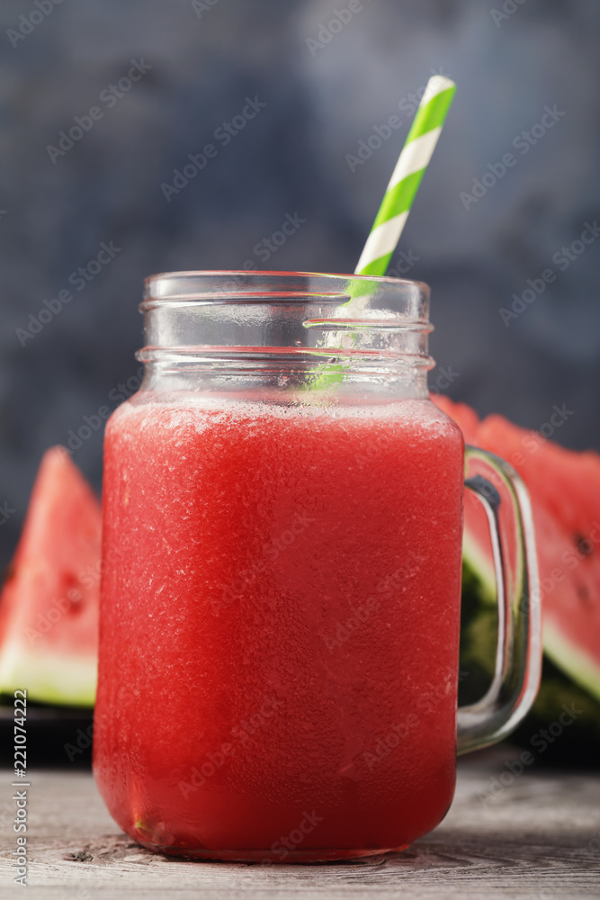 Smoothies cooked from a watermelon in a transparent jar on a wooden table, close-up Smoothies cooked from a watermelon in a transparent jar on a wooden table, close-up