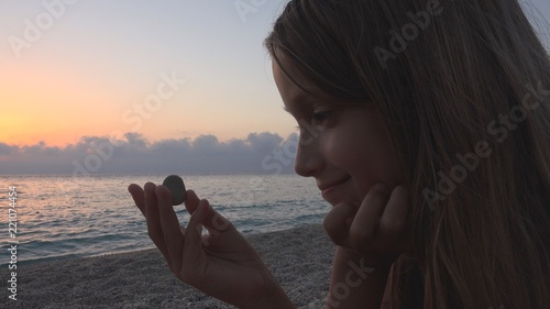 Child on Beach, Kid Playing on Shore in Sunset, Girl Watching Studying Pebbles