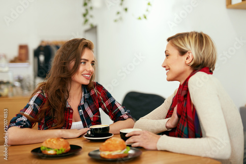 Women Friends In Cafe Drinking Coffee