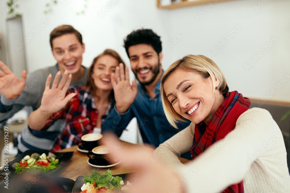 Obraz premium People At Dinner Taking Photos On Phone. Friends Video Calling