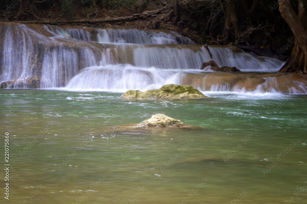 Fototapeta premium Beautiful waterfalls amidst the abundant nature with mountains and forests of Thailand.
