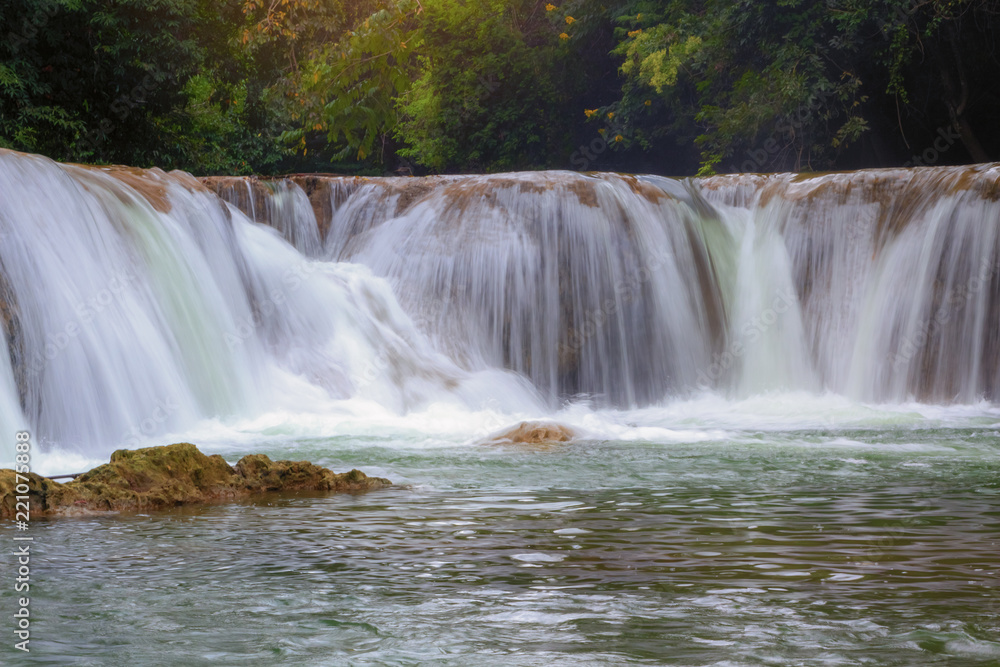 Beautiful waterfalls amidst the abundant nature with mountains and forests of Thailand.