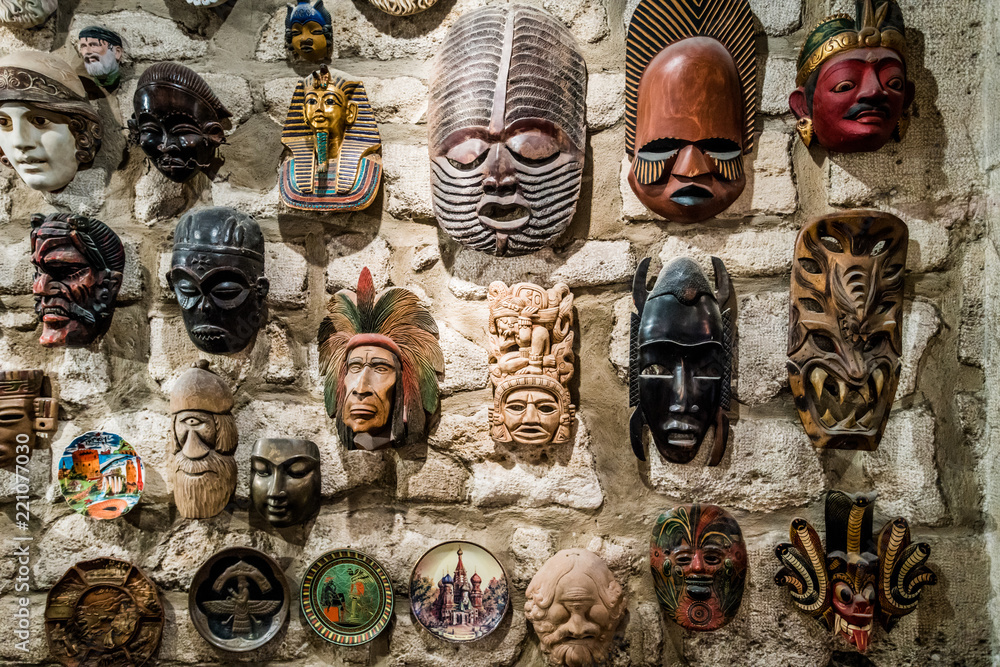 masks hanging on wall. Collection of masks Stock Photo Adobe Stock