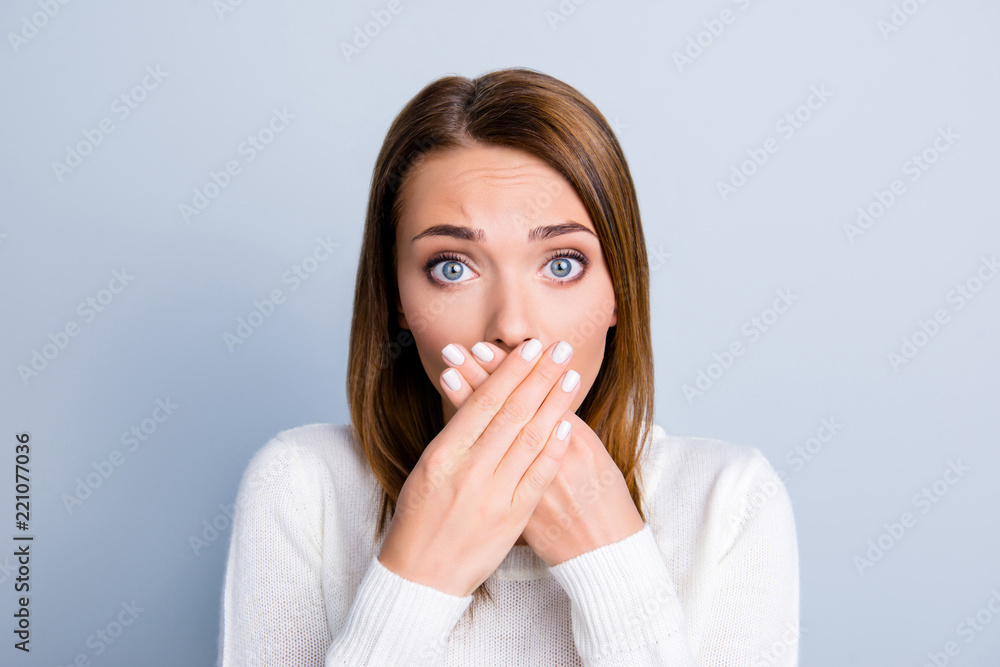 Portrait of afraid scared woman closed her mouth with crossed pa Portrait of afraid scared woman closed her mouth with crossed pa