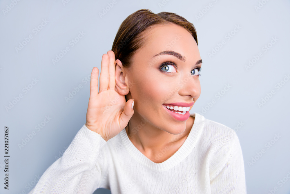 Close up portrait of funny curious woman holding palm near ear l Close up portrait of funny curious woman holding palm near ear l