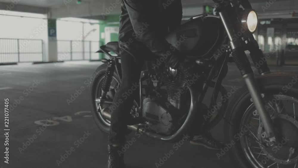 Close up of hand of the motorcyclist inserting the key into the ignition lock and turn off the engine of the bike. Urban lifestyle scene. Slow motion video shooting by handheld gimbal Close up of hand of the motorcyclist inserting the key into the ignition lock and turn off the engine of the bike. Urban lifestyle scene. Slow motion video shooting by handheld gimbal