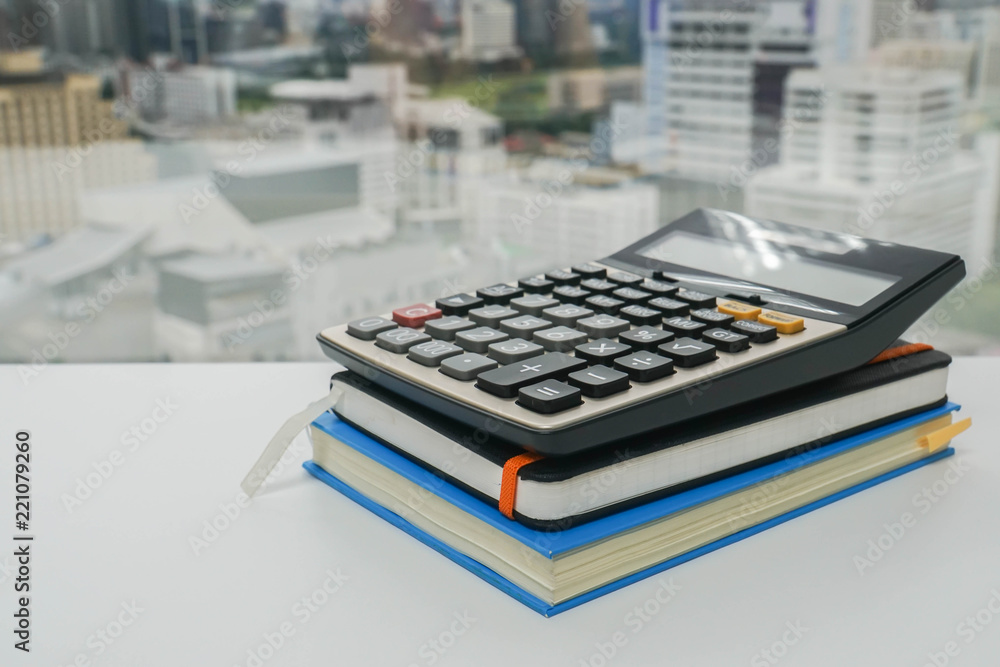 digital calculator on notebook for finance advisor working in office