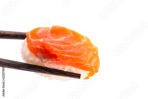 Close-up of Orange fresh salmon sushi nigiri in chopsticks isolated on white