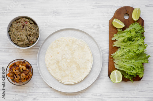 Shrimp taco ingredients on white wooden background, top view. Flat lay, overhead, from above.