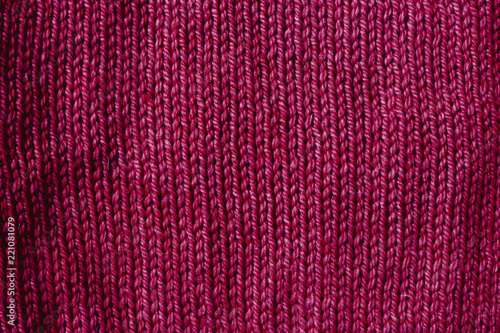 Fototapeta premium trend red pear woolen knitted background, texture, close-up