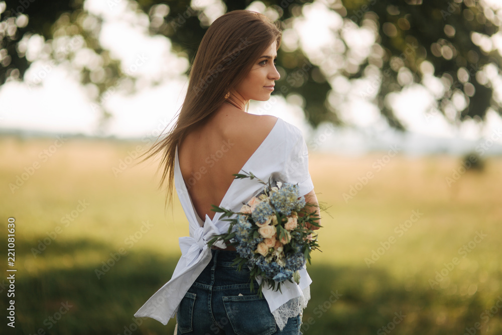 Beautiful mother have flower bouquet and have a good time near the nature Beautiful mother have flower bouquet and have a good time near the nature
