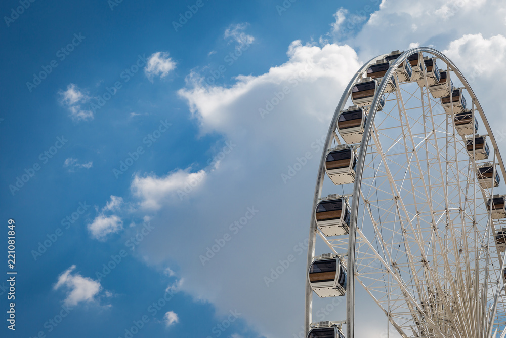 White big Ferris wheel  with blue sky sharp clouds