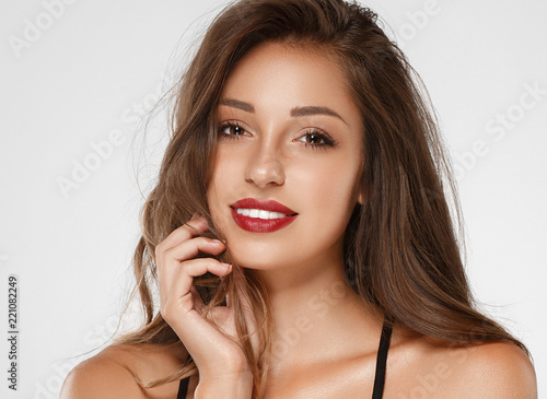 Beautiful woman brunette with tanned skin and red lips beauty 