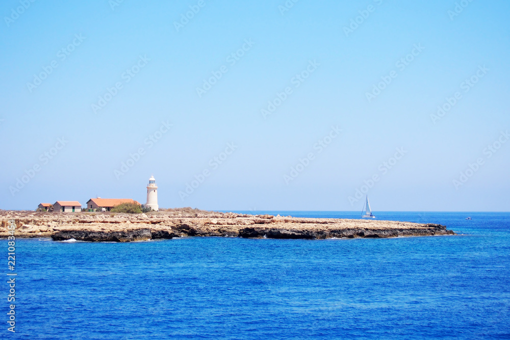 Very beautiful seascape with a lighthouse on the cape outstanding in the sea