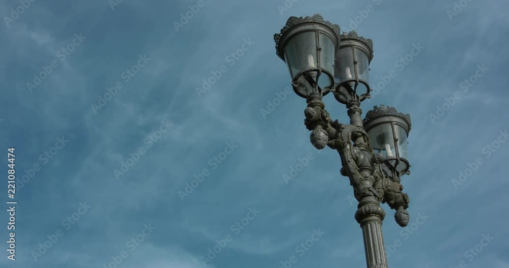 Old rustic street lamps in central Stockholm. Moving 4K slow motion shot with a blue sky backdrop. Old rustic street lamps in central Stockholm. Moving 4K slow motion shot with a blue sky backdrop.