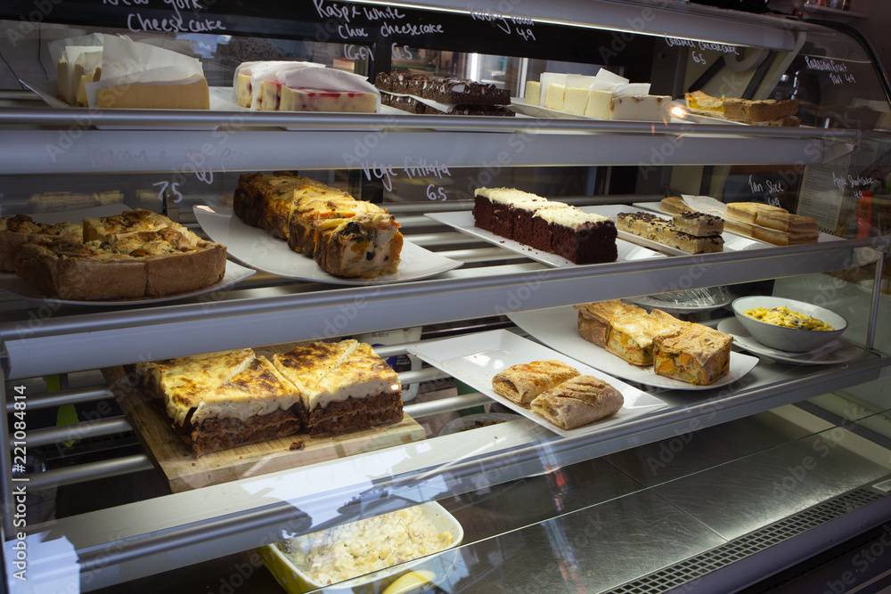 The food cabinet in a cafe offers a variety of dishes to customers