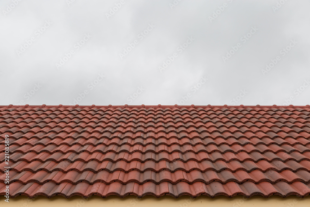 Roof tile pattern over sky background